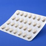HRT Hormone Replacement Therapy tablets on a blue background