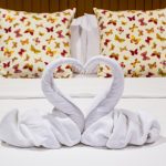 couple's bed with swan towels