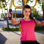 brunette woman working out outdoors