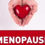 menopause with red heart shape in woman's hand