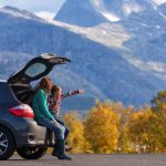 mother and daughter outside with mountains in background