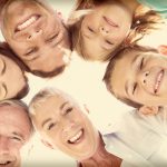 multi-generational family smiling and looking down