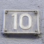 number 10 metal sign on building