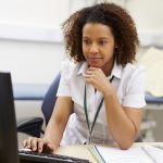 nurse working at her desk doing paperwork