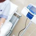 patient laying on hospital bed getting chemotherapy