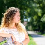 sad woman sitting outside on park bench