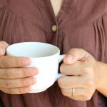 woman holding coffee cup