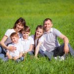 family sitting outside in grass