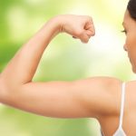 woman flexing arm outside