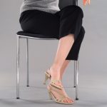woman sitting in chair with legs crossed