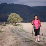 women in pink shirt nordic walking